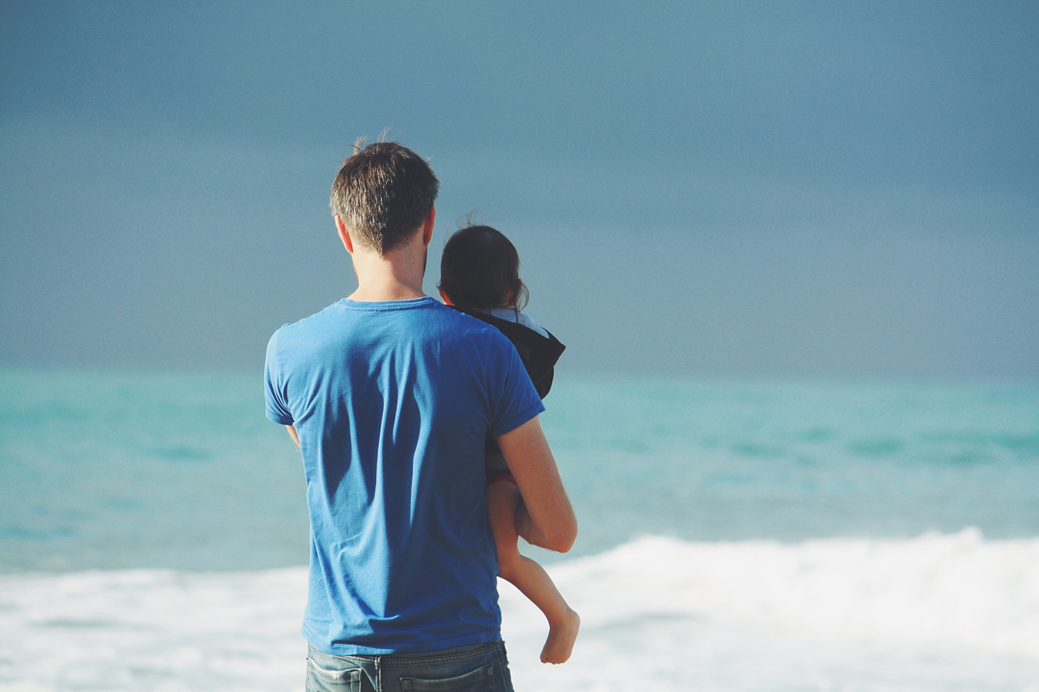 vader en kind op het strand